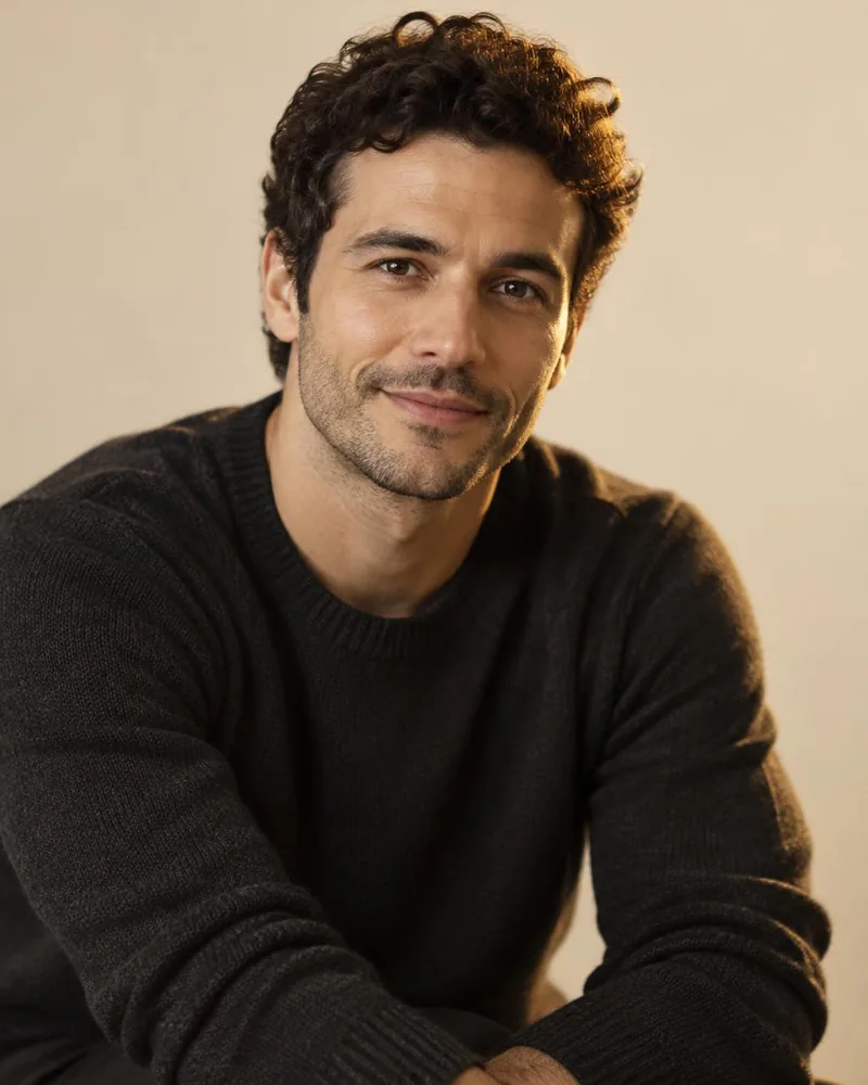 AI-generated portrait of a fictional man in a charcoal sweater against an ivory backdrop